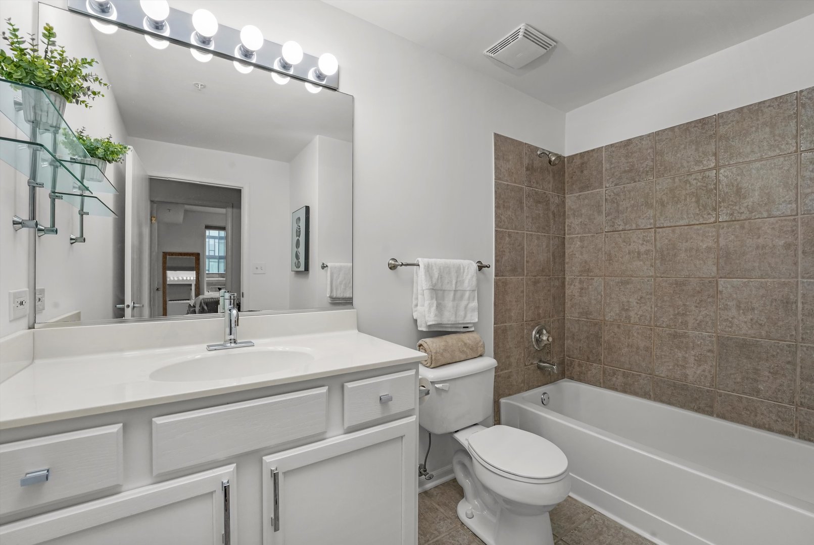 515 Main Street, Unit 307 Evanston, IL 60202 - Photo 12 of 29 a bathroom with a sink a toilet a mirror and shower