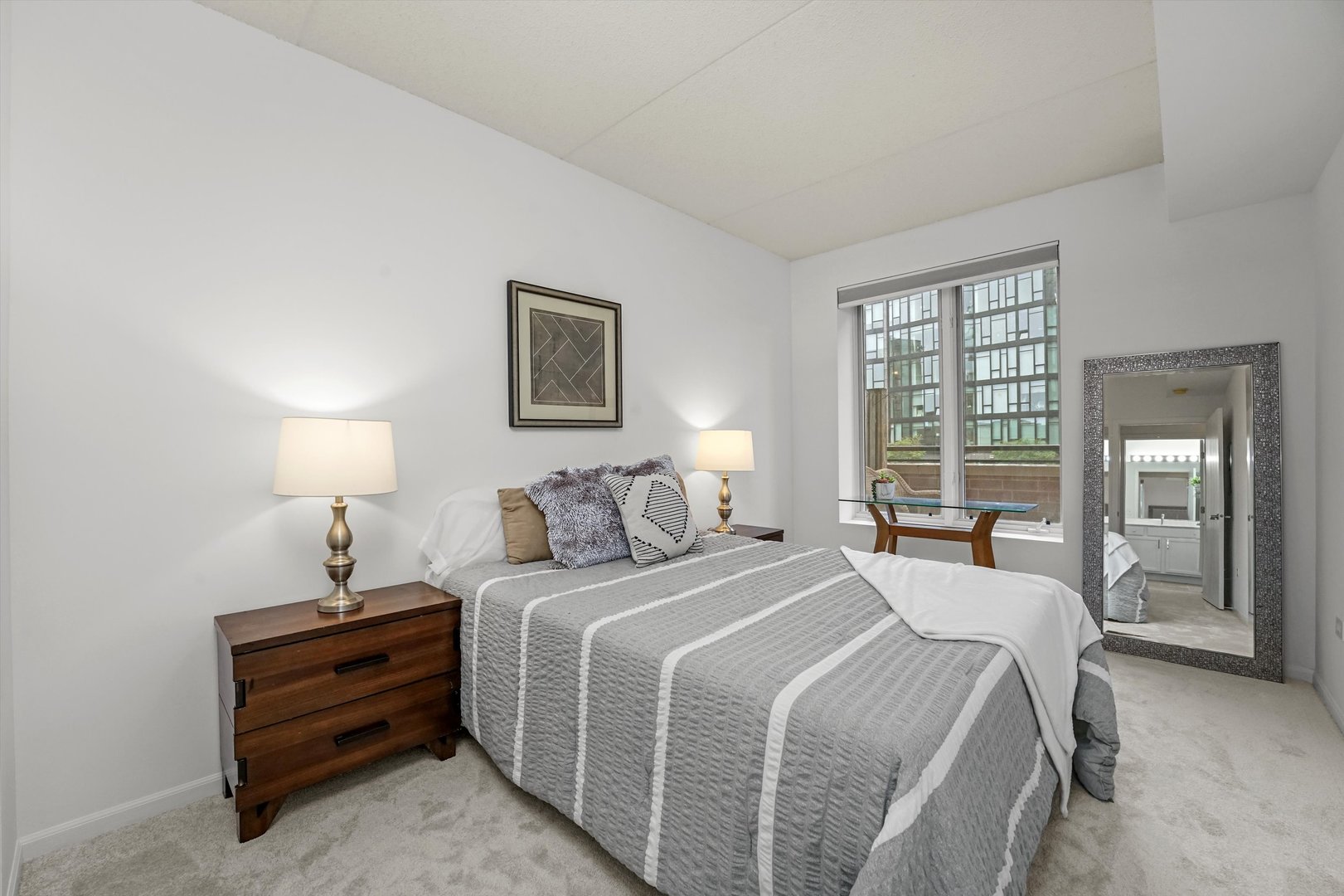 515 Main Street, Unit 307 Evanston, IL 60202 - Photo 14 of 29 a bedroom with a bed and a lamp