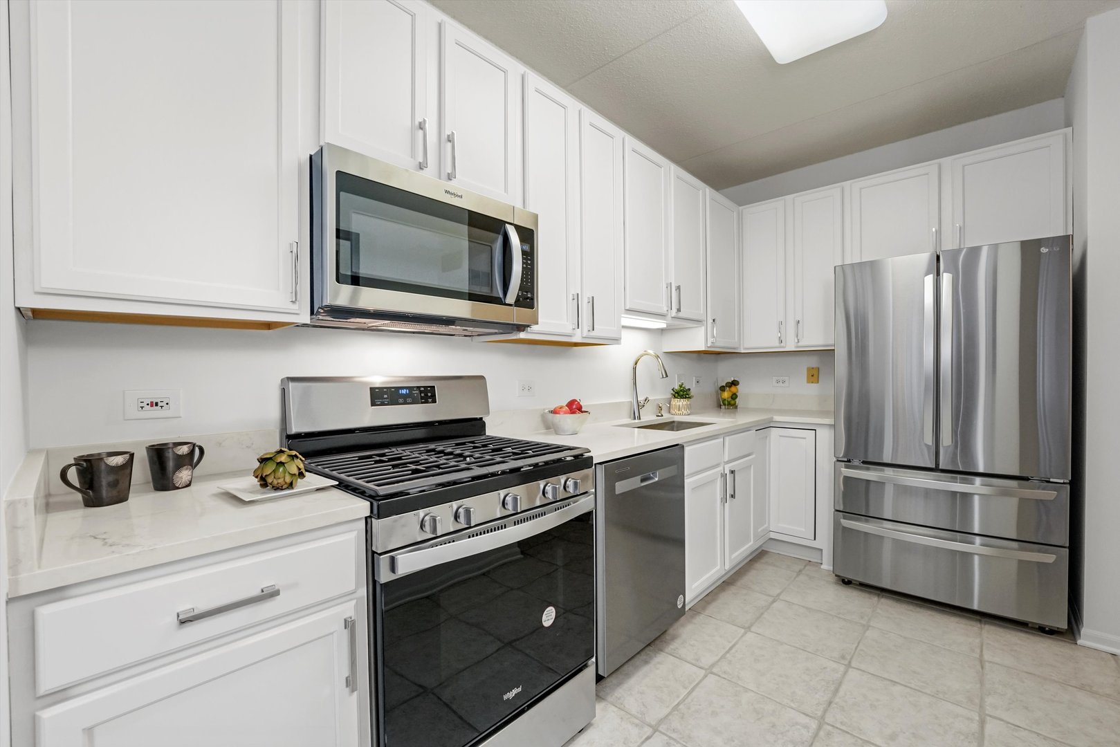 515 Main Street, Unit 307 Evanston, IL 60202 - Photo 5 of 29 a kitchen with cabinets stainless steel appliances and a sink