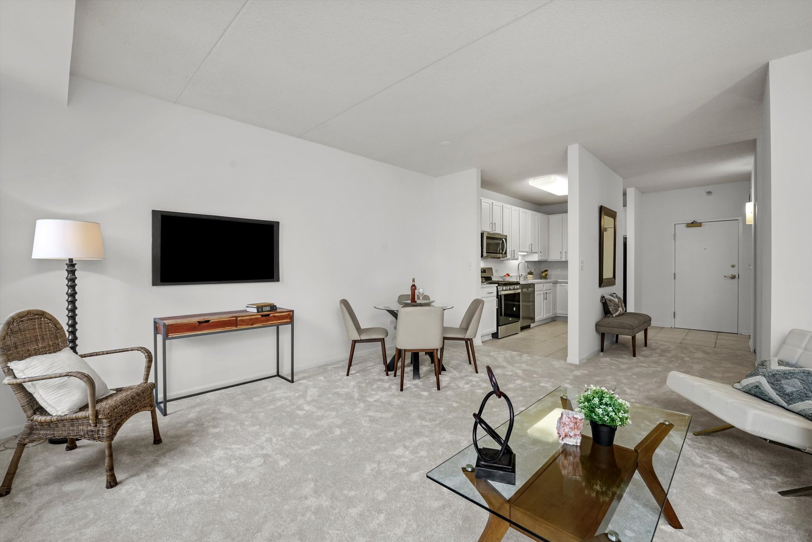515 Main Street, Unit 307 Evanston, IL 60202 - Photo 7 of 29 a living room with furniture and a flat screen tv