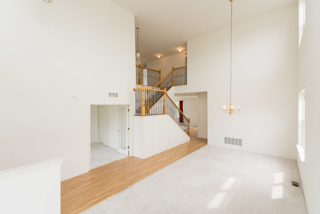 1605 Manhattan Street Bolingbrook, IL 60490 - Photo 9 of 29 a view of a room with wooden floor and staircase