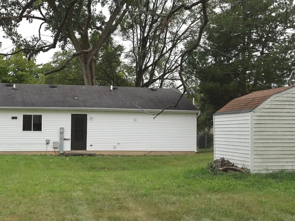 a view of house with backyard