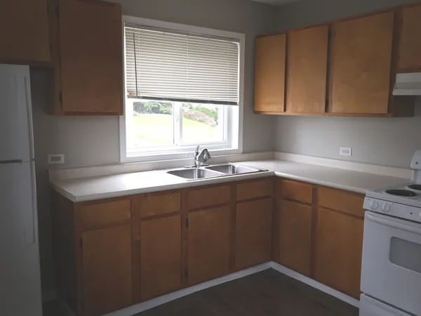 a kitchen with a sink cabinets and window
