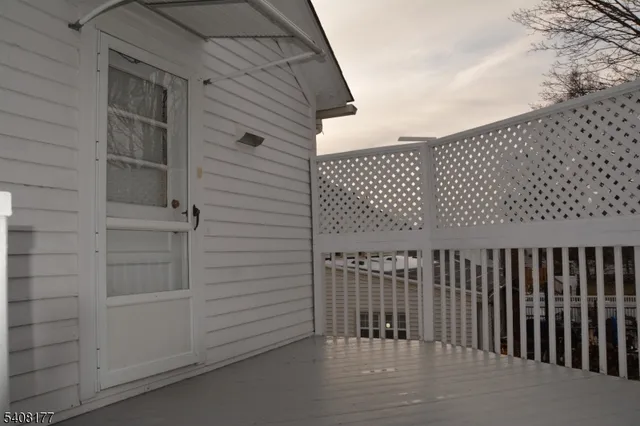 a front view of a house with iron stairs