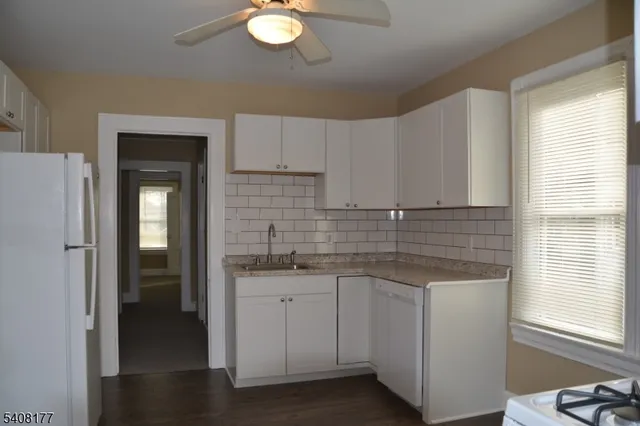 a kitchen with sink cabinets and window