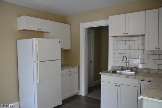 a white refrigerator freezer sitting inside of a kitchen
