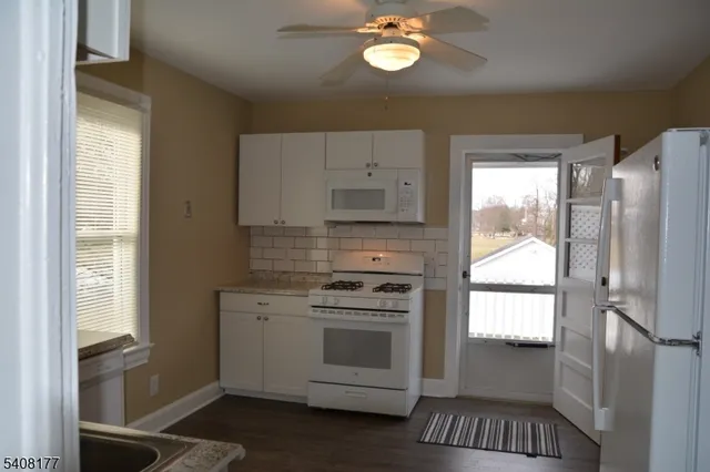 a kitchen with a refrigerator stove and a sink