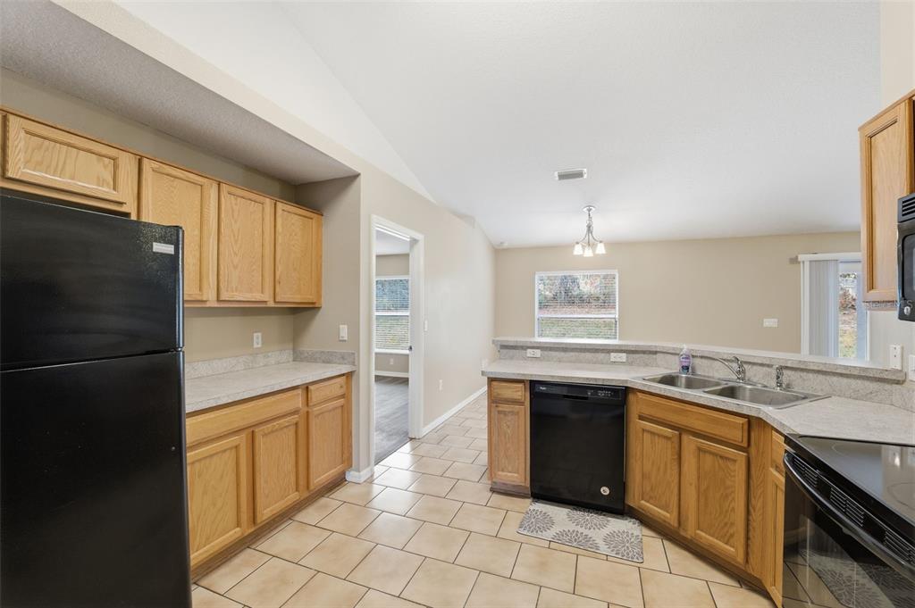 13477 Amanda Avenue Spring Hill, FL 34609 - Photo 11 of 46 a kitchen with a sink stove and refrigerator