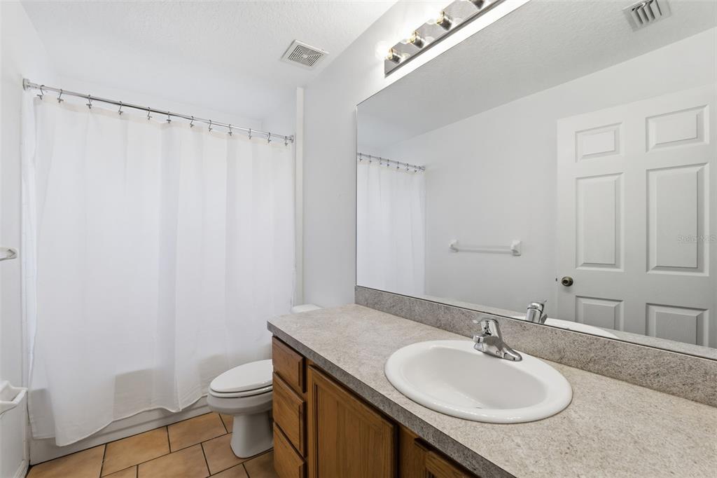 13477 Amanda Avenue Spring Hill, FL 34609 - Photo 20 of 46 a bathroom with a granite countertop sink toilet and a mirror
