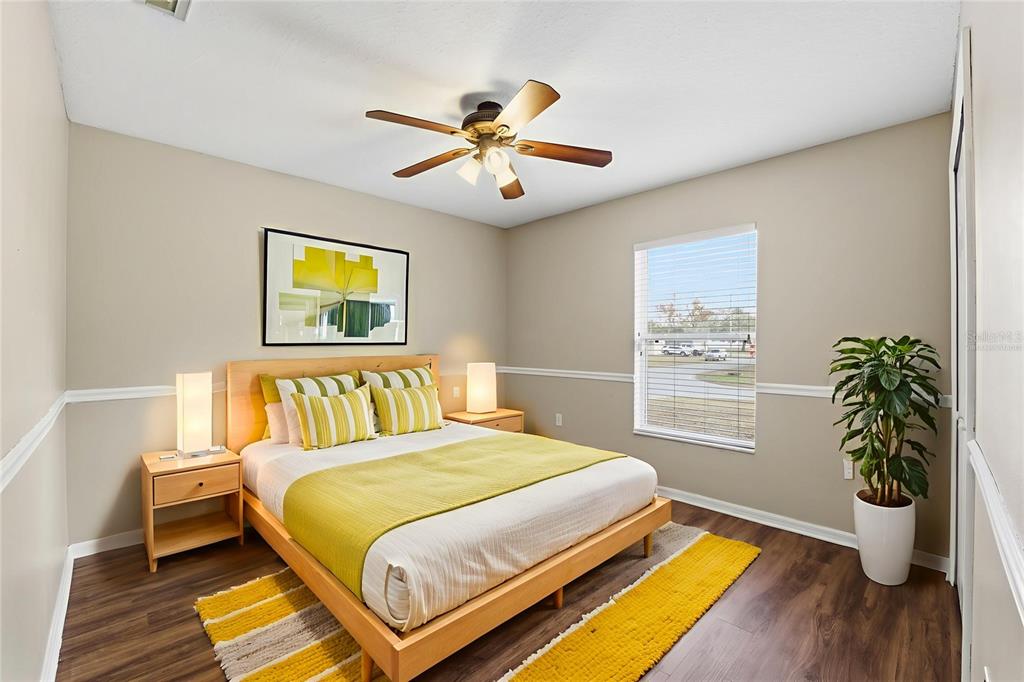 13477 Amanda Avenue Spring Hill, FL 34609 - Photo 22 of 46 a bedroom with a bed and a potted plant