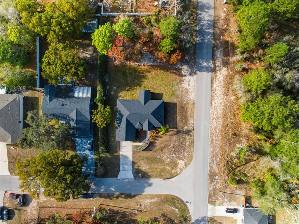 13477 Amanda Avenue Spring Hill, FL 34609 - Photo 29 of 46 an aerial view of a house with a yard and large trees
