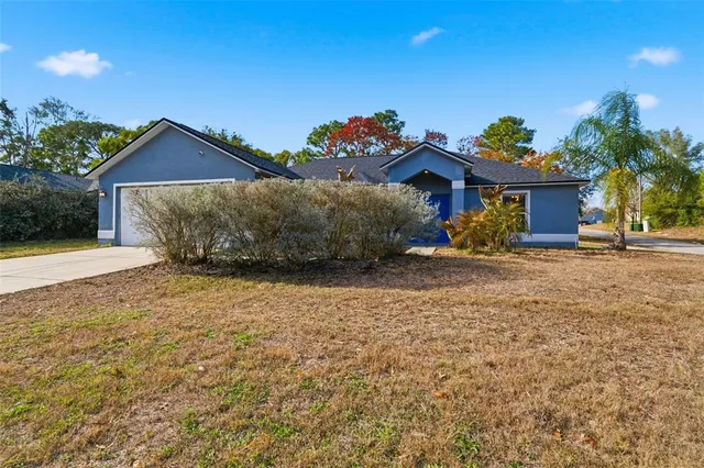 a front view of a house with a yard and a garage