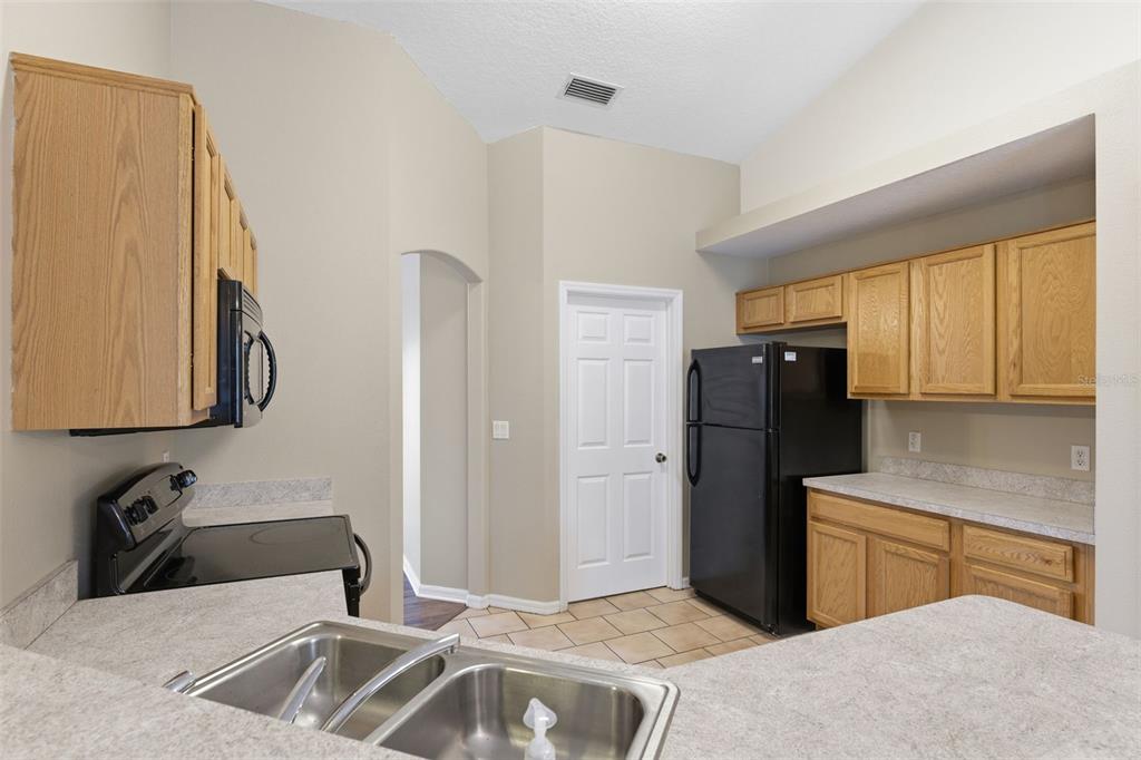 13477 Amanda Avenue Spring Hill, FL 34609 - Photo 40 of 46 a kitchen with a refrigerator and a sink