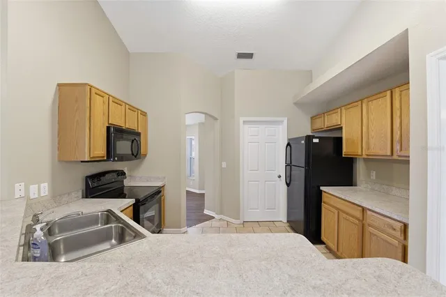 a kitchen with a refrigerator and a sink