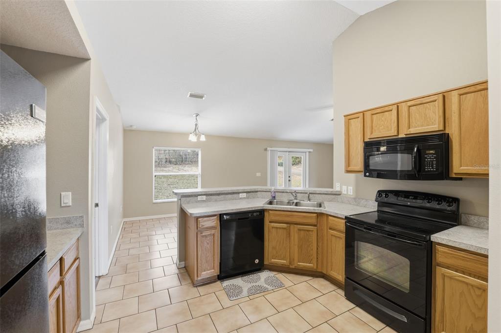 13477 Amanda Avenue Spring Hill, FL 34609 - Photo 42 of 46 a kitchen with a sink stove and microwave