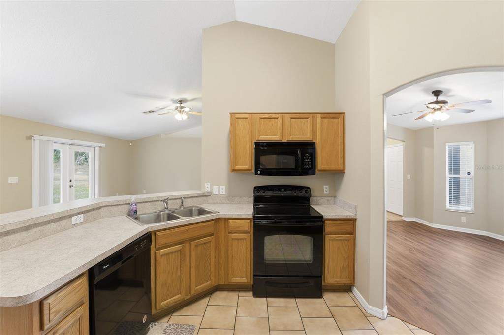 13477 Amanda Avenue Spring Hill, FL 34609 - Photo 43 of 46 a kitchen with a sink and a stove top oven