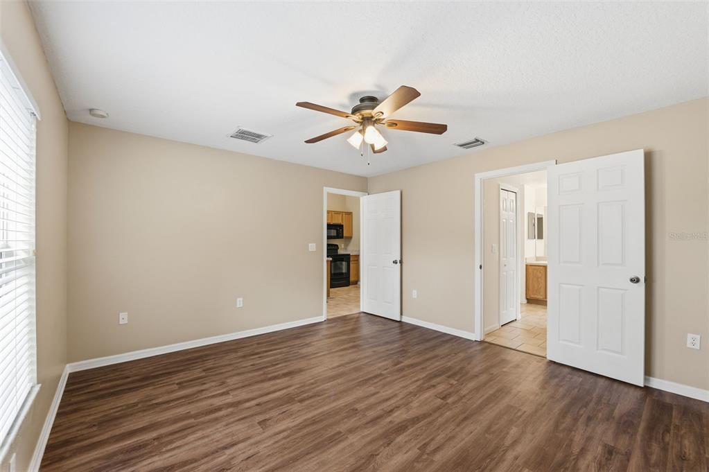 13477 Amanda Avenue Spring Hill, FL 34609 - Photo 44 of 46 an empty room with wooden floor and windows
