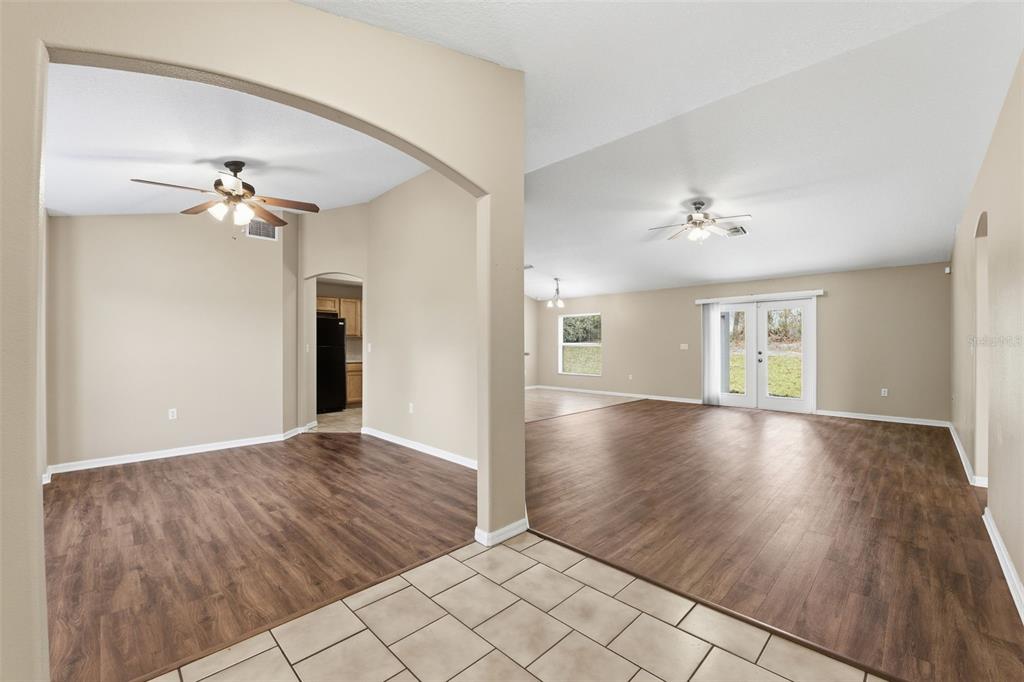 13477 Amanda Avenue Spring Hill, FL 34609 - Photo 5 of 46 a view of an empty room with a window and wooden floor