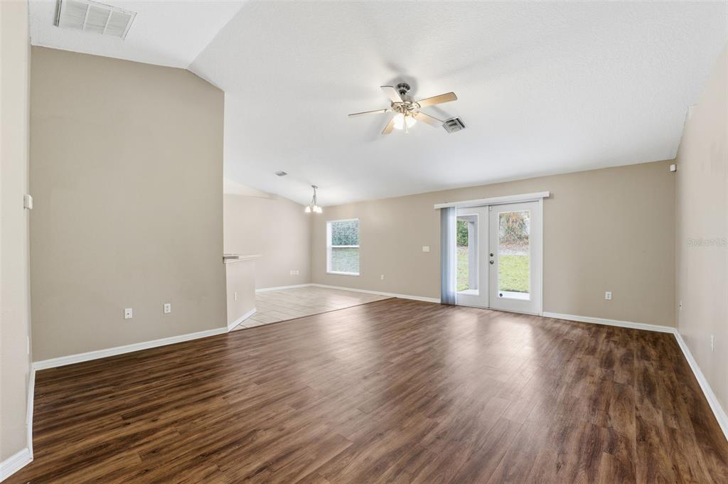 13477 Amanda Avenue Spring Hill, FL 34609 - Photo 6 of 46 a view of an empty room with wooden floor and window