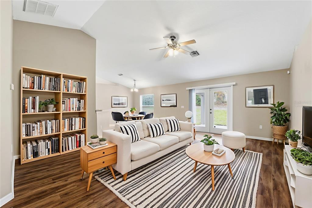 13477 Amanda Avenue Spring Hill, FL 34609 - Photo 7 of 46 a living room with furniture and a book shelf