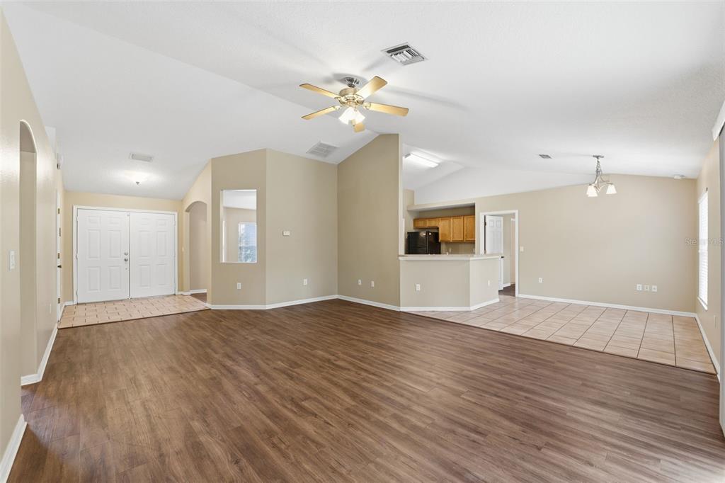 13477 Amanda Avenue Spring Hill, FL 34609 - Photo 8 of 46 a view of an empty room with wooden floor and a ceiling fan