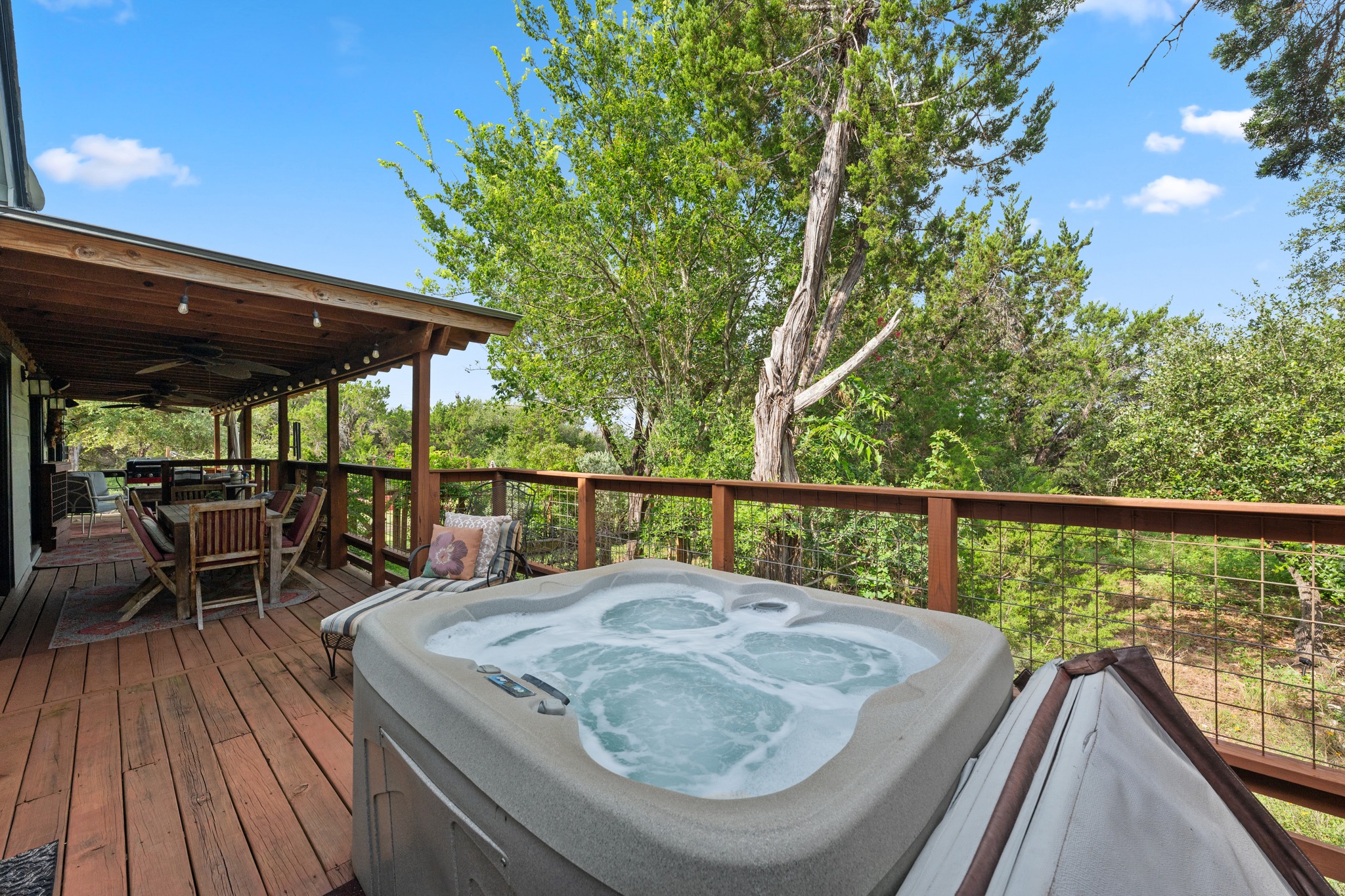 12932 Nutty Brown Road Austin, TX 78737 - Photo 13 of 40 The Cabin - Private hot tub on the covered deck, perfect for relaxing under the Texas sky.