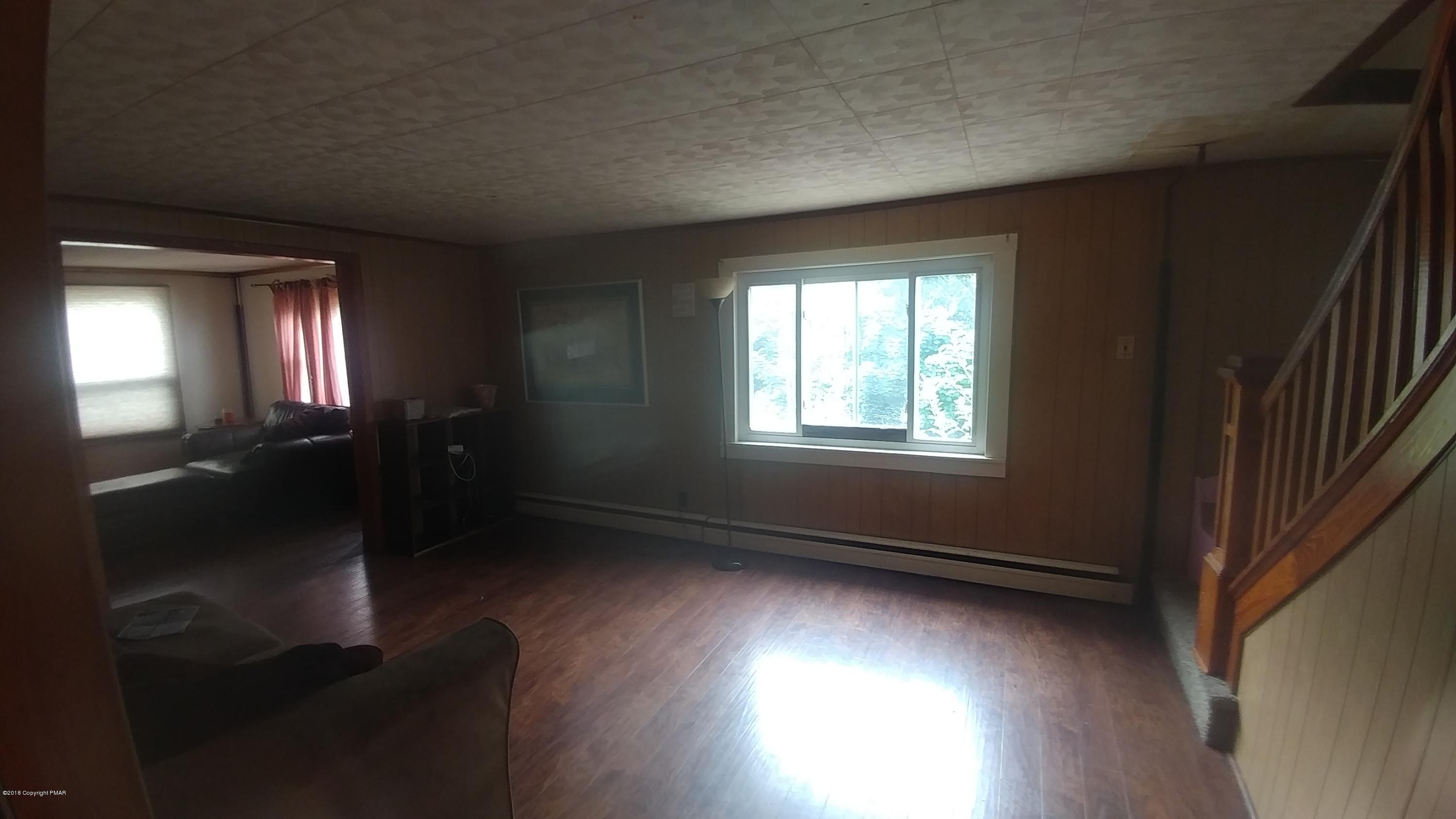 604 Lilly Lake Road Wapwallopen, PA 18660 - Photo 10 of 16 an empty room with wooden floor and windows