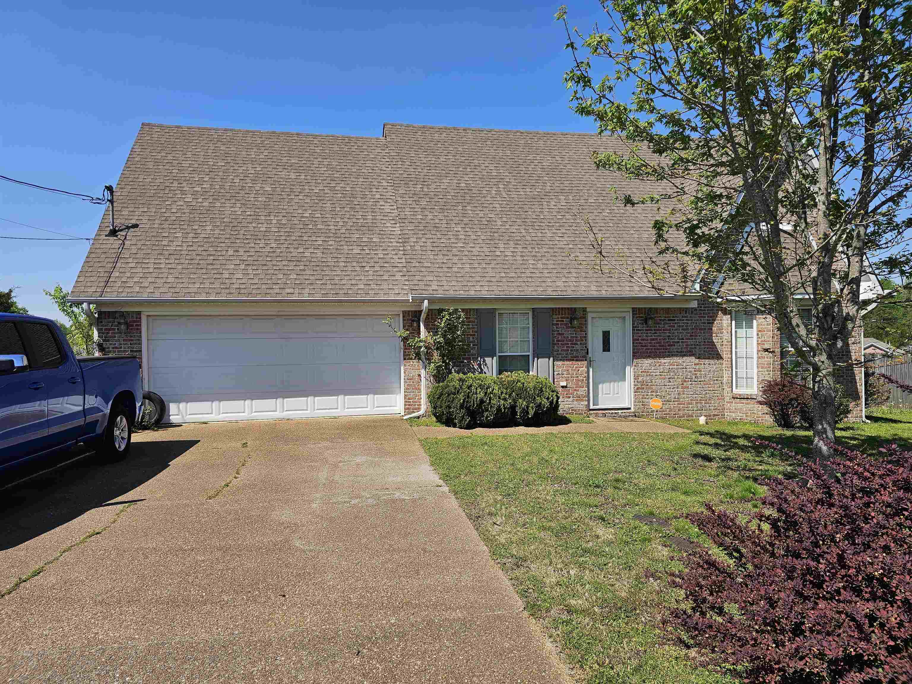 109 Sebastian Drive Jackson, TN 38305 - Photo 1 of 24 View of front of home featuring driveway, a garage, roof with shingles, and brick siding