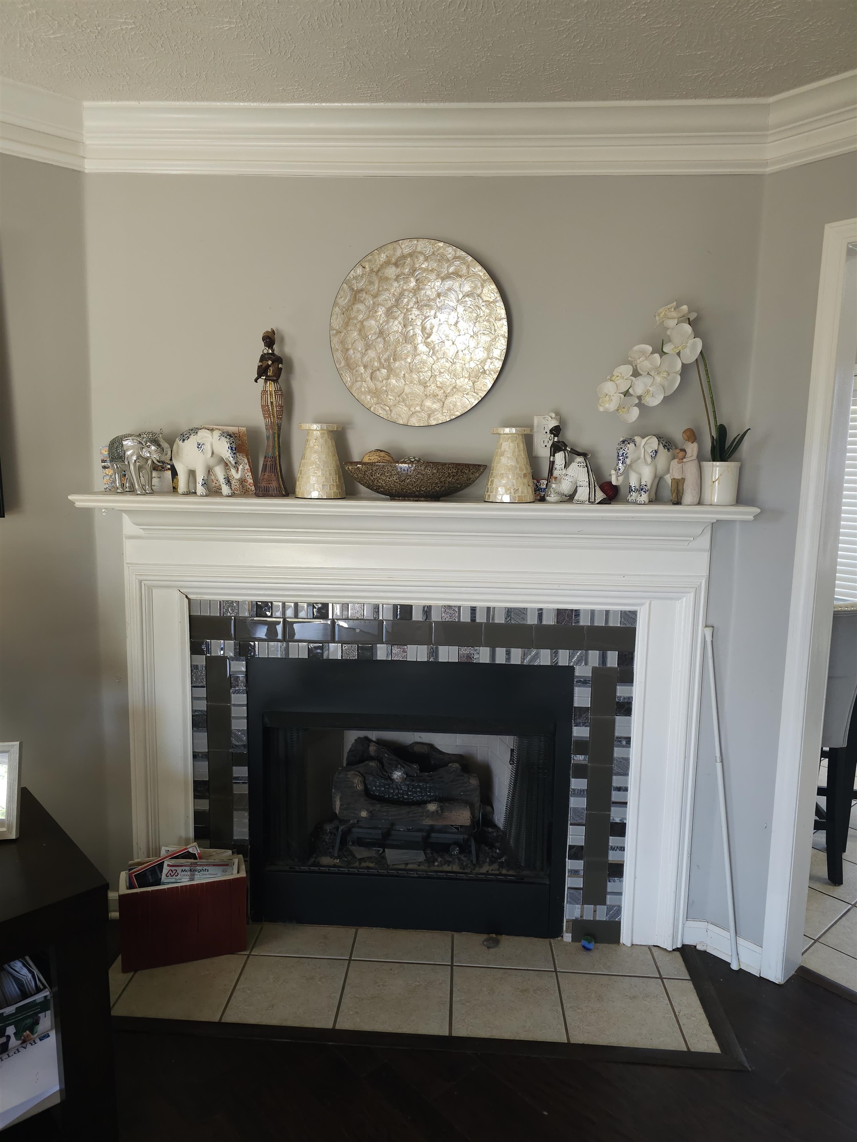 109 Sebastian Drive Jackson, TN 38305 - Photo 5 of 24 Detailed view of a tiled fireplace, ornamental molding, and a textured ceiling