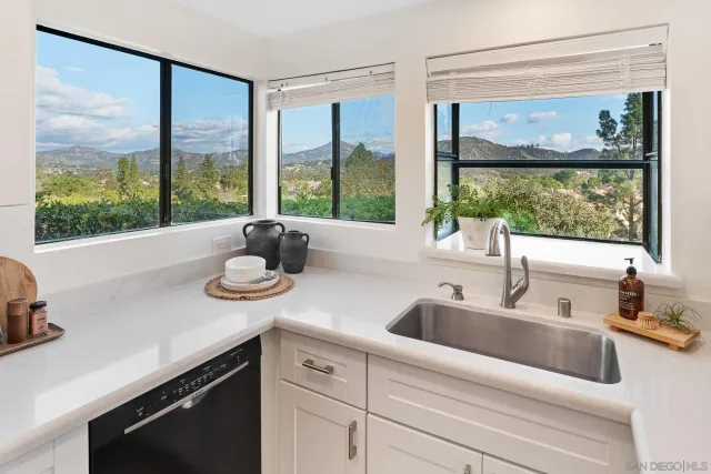 a kitchen with a sink and a large window