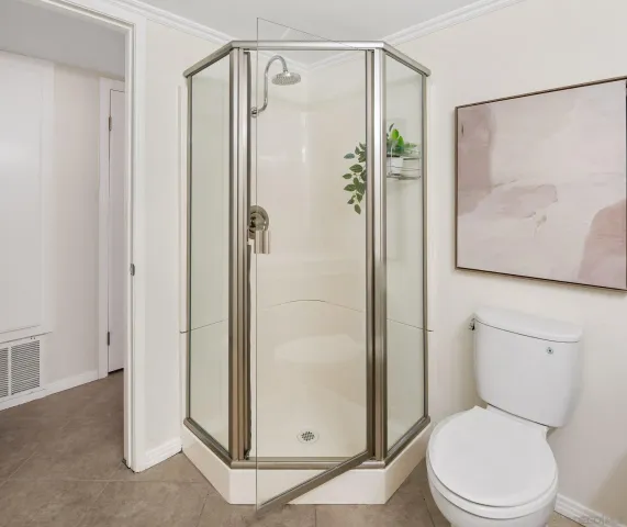 a white toilet sitting next to a bathroom