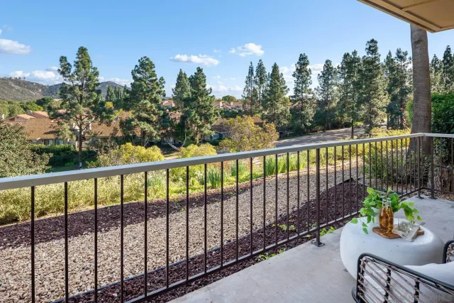 a view of a two chairs in the balcony
