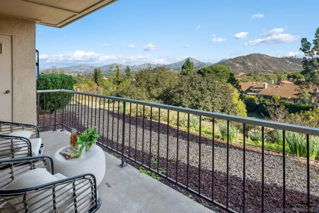 a view of a balcony with furniture