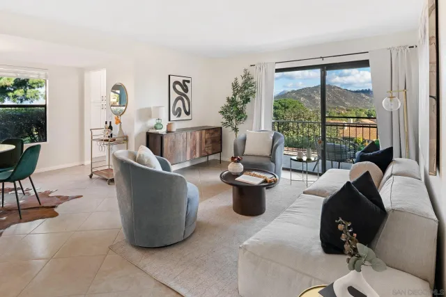 a living room with furniture a large window and a potted plant