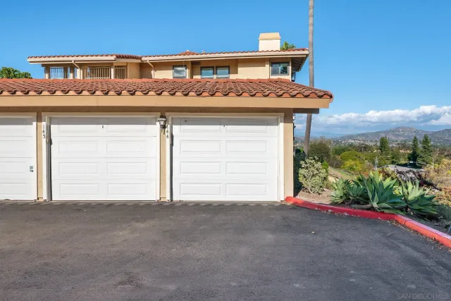 a view of a house with a big yard and potted plants