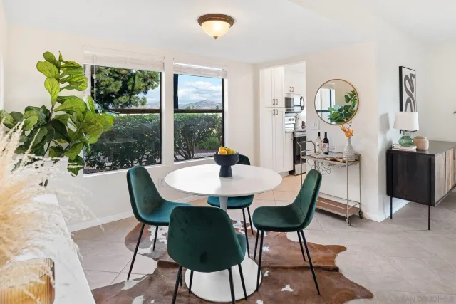a living room filled with furniture and a potted plant