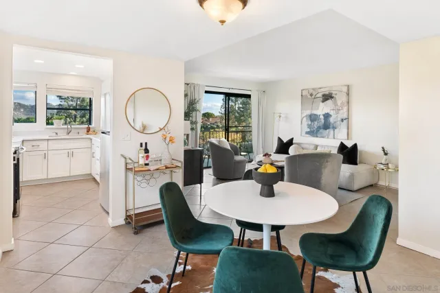 a view of a dining room with furniture and a potted plant
