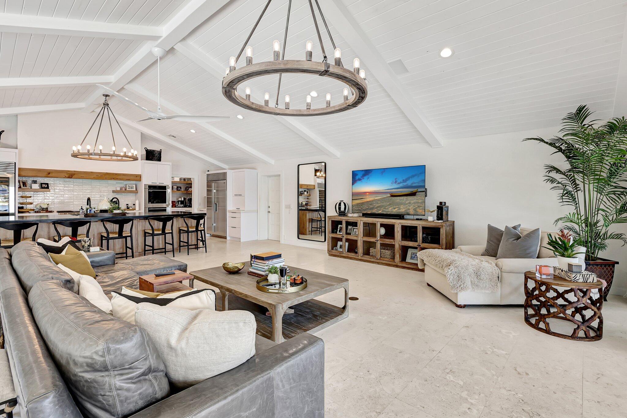 18896 Point Drive Tequesta, FL 33469 - Photo 23 of 62 a living room with furniture kitchen view and a chandelier