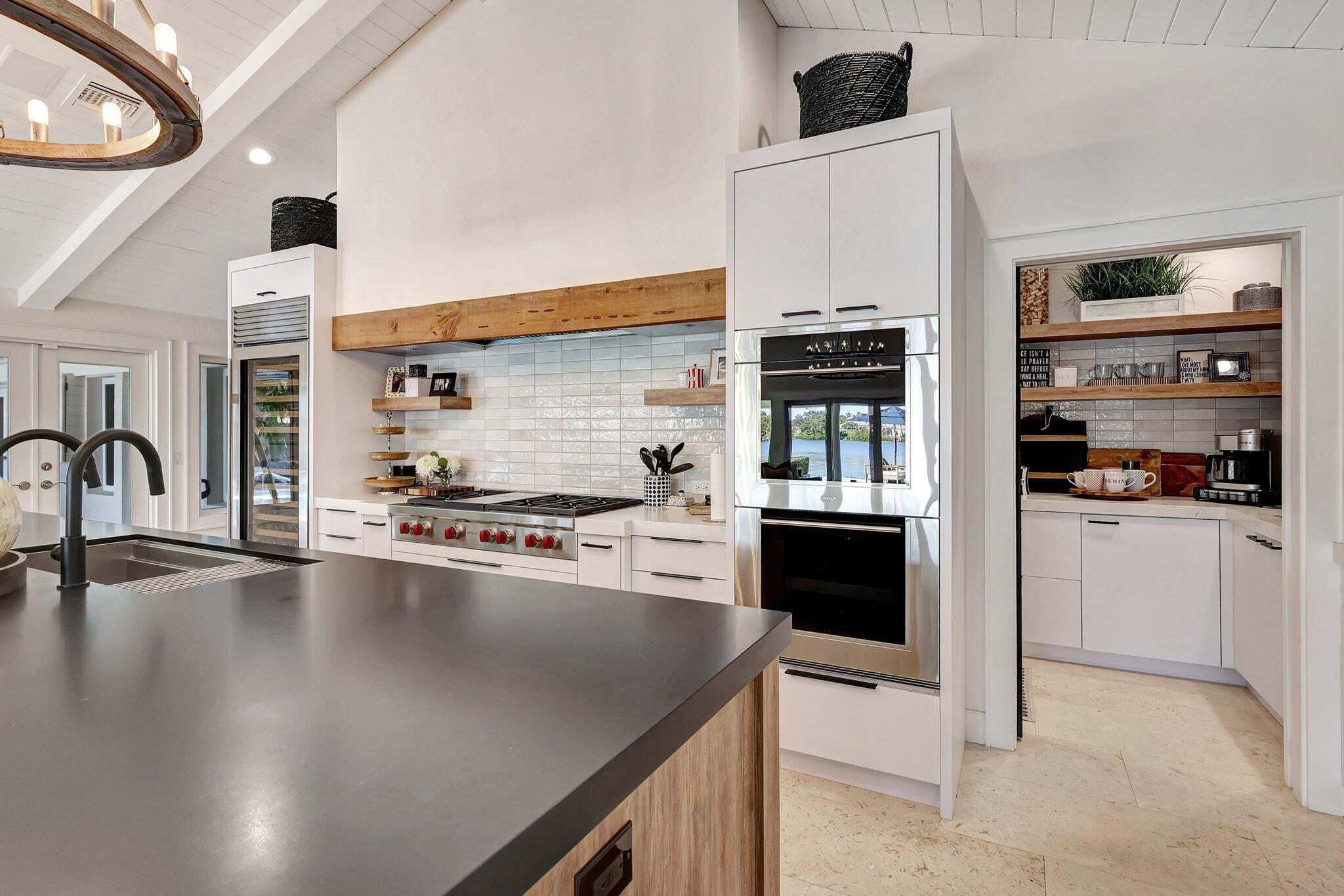 18896 Point Drive Tequesta, FL 33469 - Photo 29 of 62 a kitchen with stainless steel appliances a stove a sink and a refrigerator