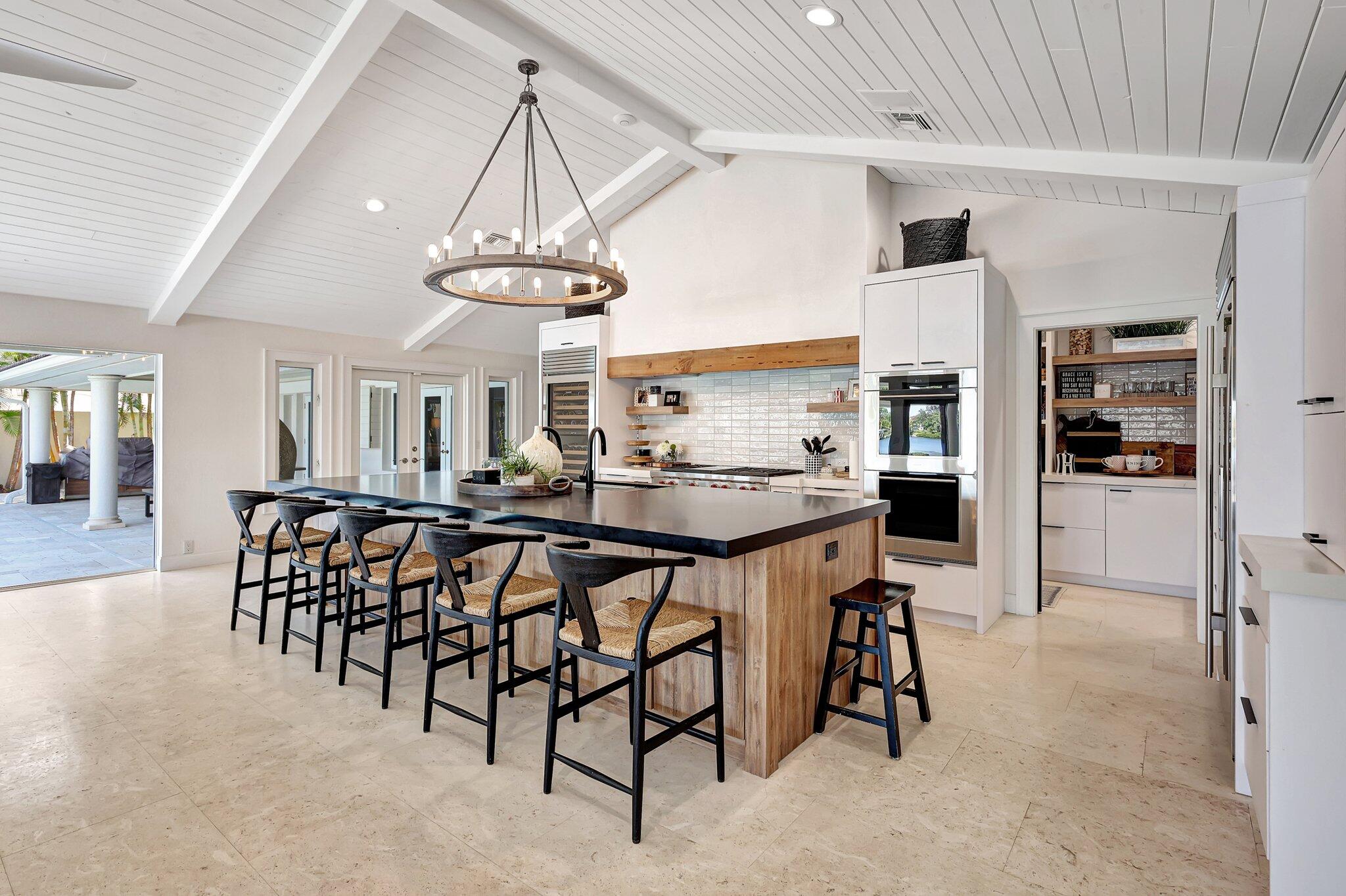 18896 Point Drive Tequesta, FL 33469 - Photo 30 of 62 a view of a dining room with furniture and a chandelier