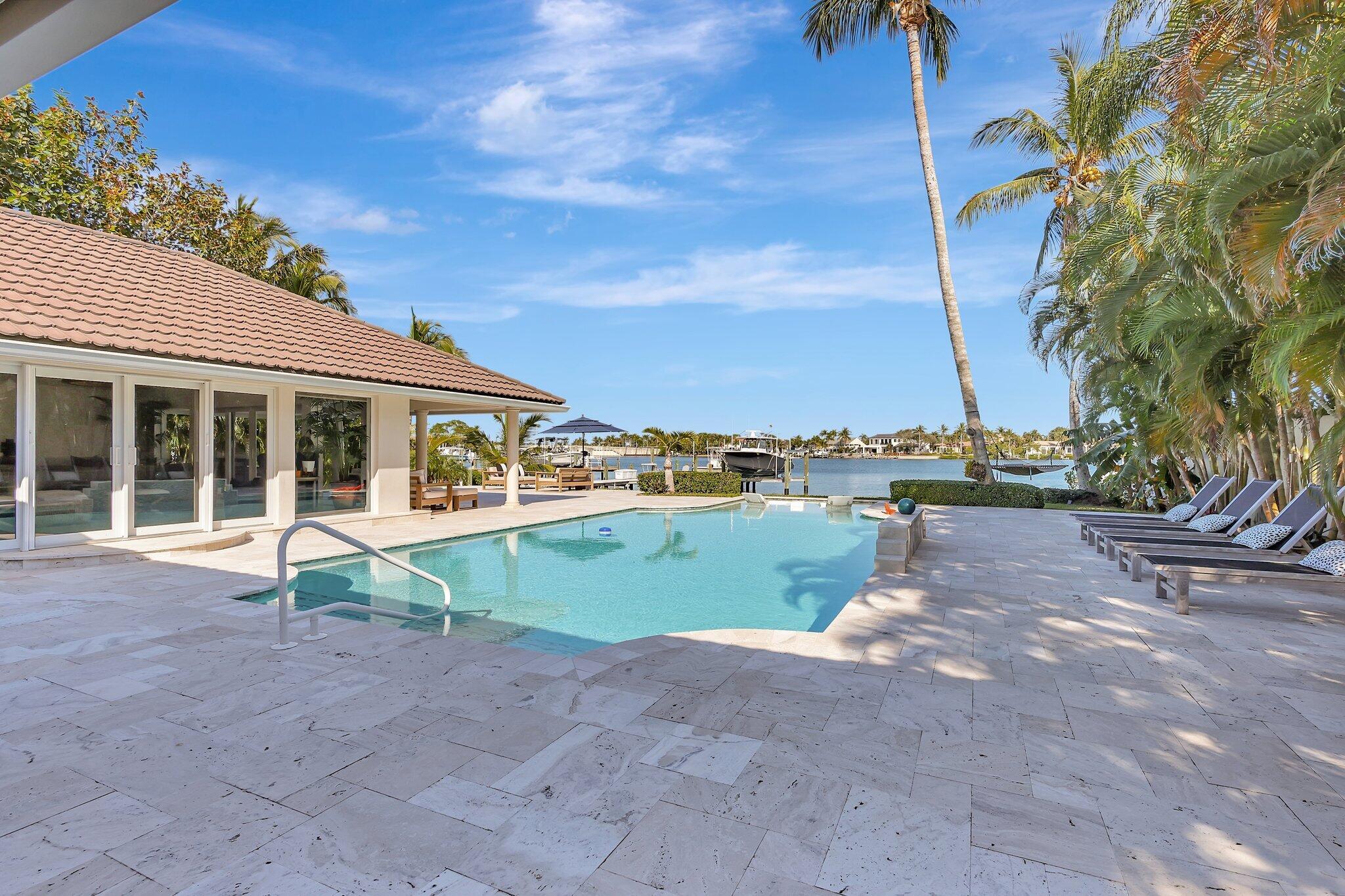 18896 Point Drive Tequesta, FL 33469 - Photo 40 of 62 a view of a house with backyard and a garden