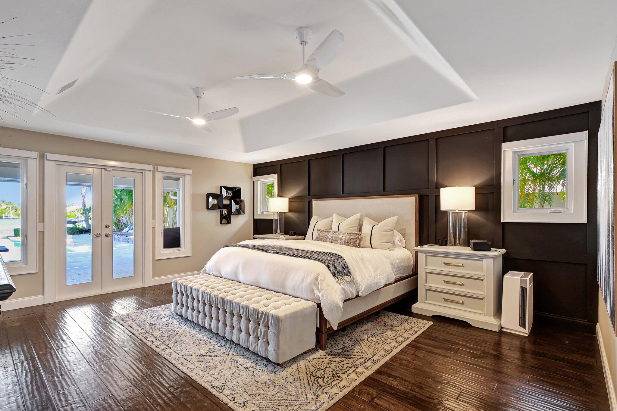 18896 Point Drive Tequesta, FL 33469 - Photo 43 of 62 a bedroom with a bed and wooden floor