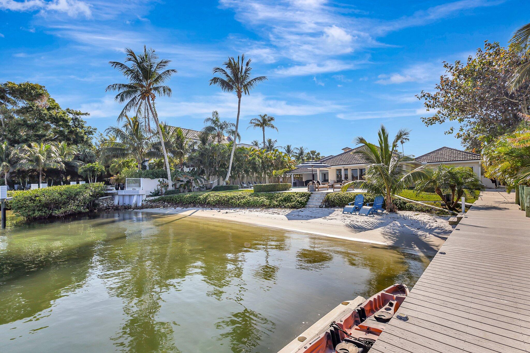 18896 Point Drive Tequesta, FL 33469 - Photo 7 of 62 a view of swimming pool with a table and chairs