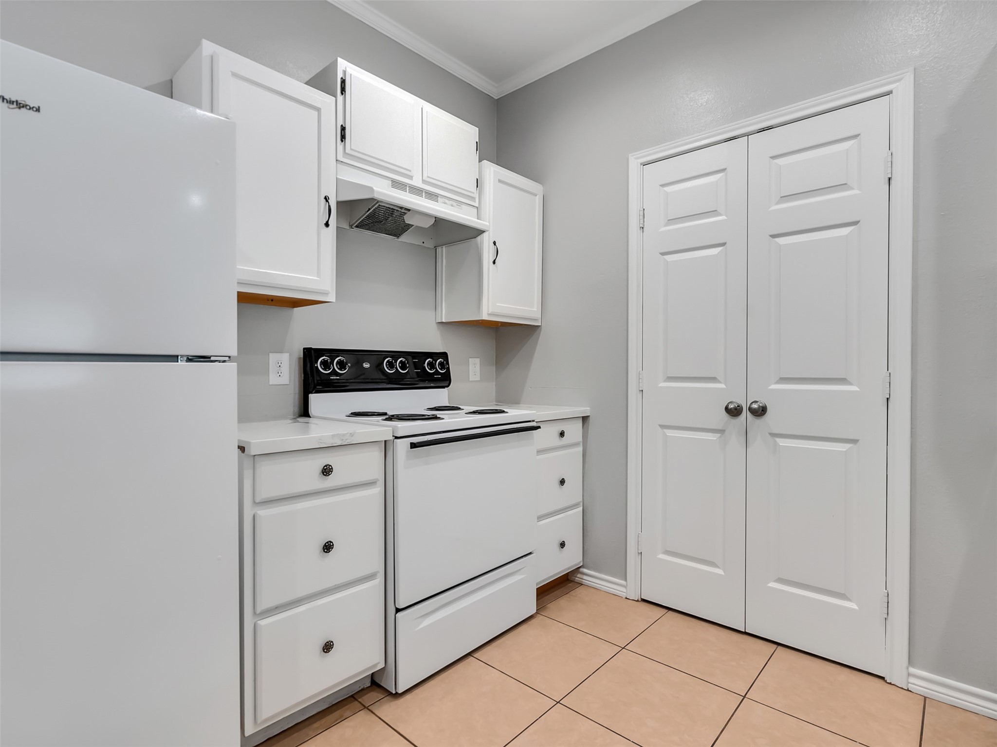 104 Longstreet Road, Unit 2 Willis, TX 77378 - Photo 15 of 26 a kitchen with white cabinets and white appliances