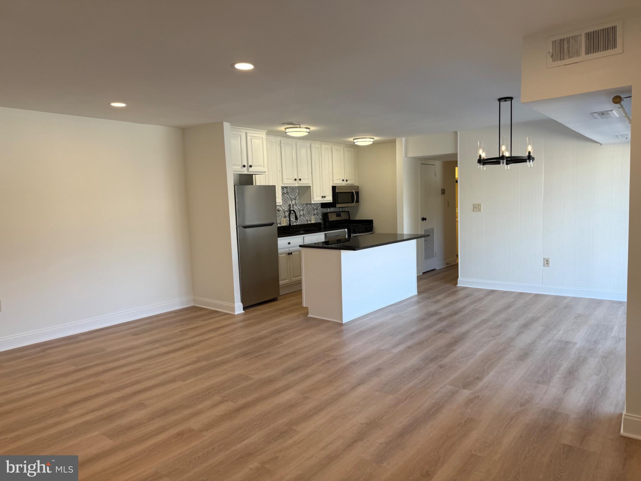 3842 Bel Pre Road, Unit 12 Silver Spring, MD 20906 - Photo 3 of 14 a kitchen with stainless steel appliances a refrigerator and a sink