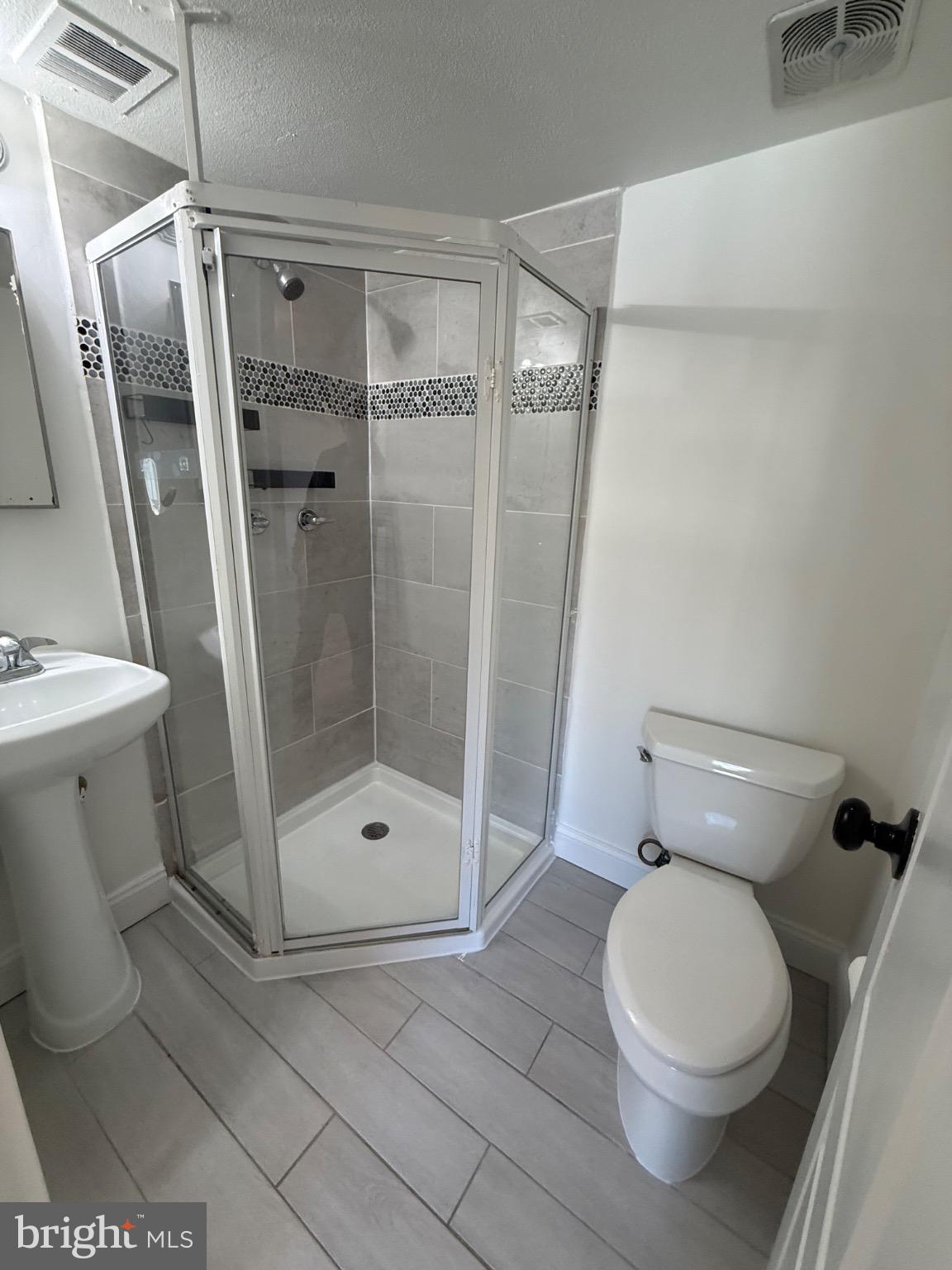 3842 Bel Pre Road, Unit 12 Silver Spring, MD 20906 - Photo 7 of 14 a bathroom with a toilet and a shower