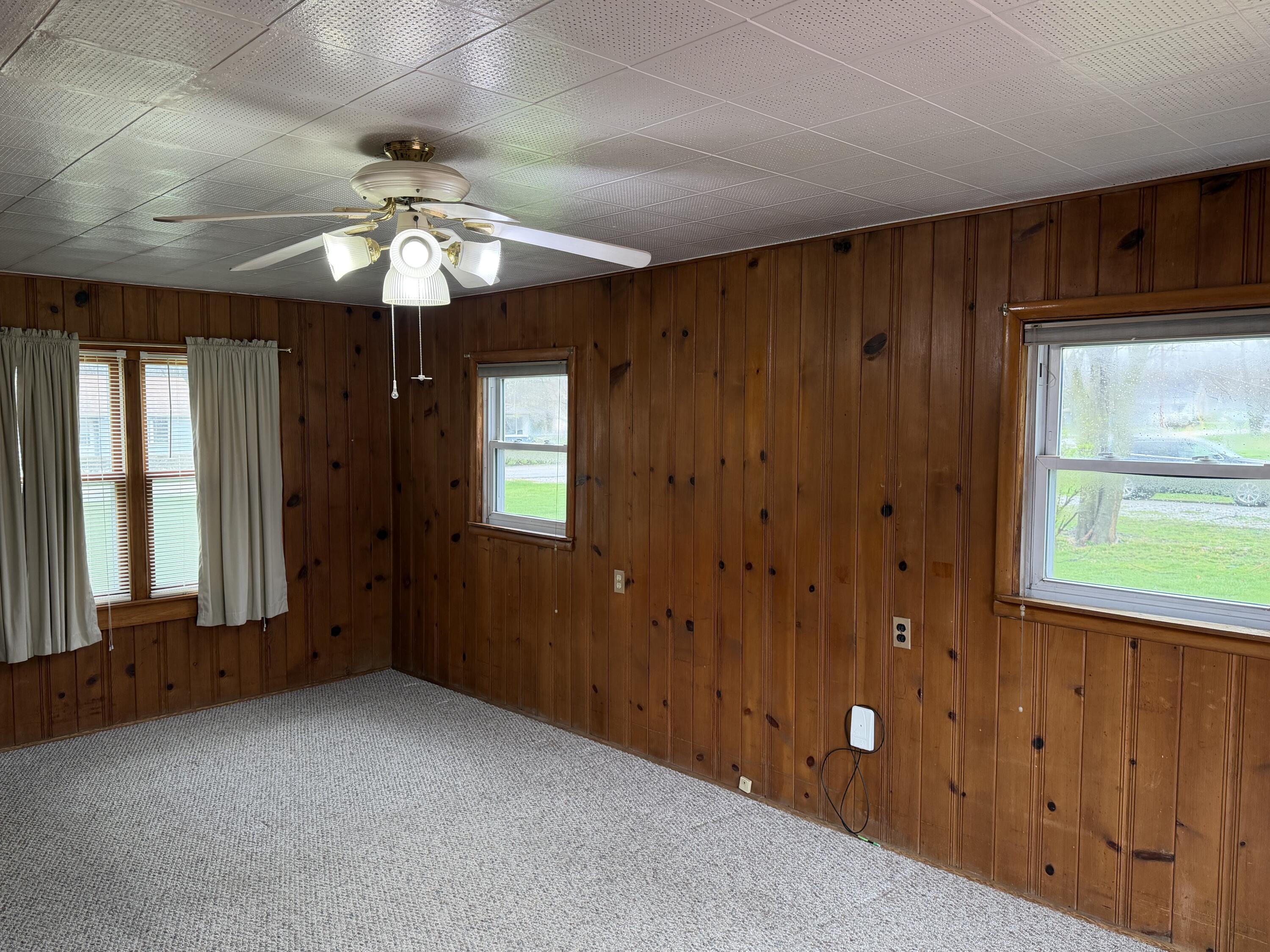 2945 Monnier Street Portage, IN 46368 - Photo 14 of 32 an empty room with chandelier fan and windows