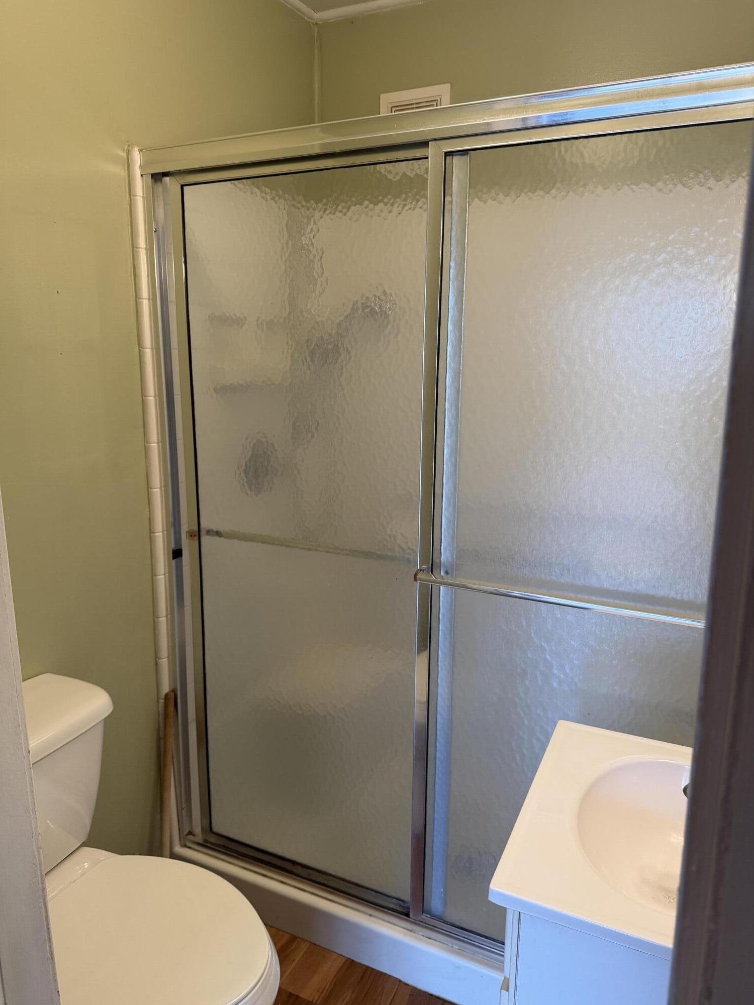 2945 Monnier Street Portage, IN 46368 - Photo 21 of 32 a bathroom with a shower a toilet and a sink
