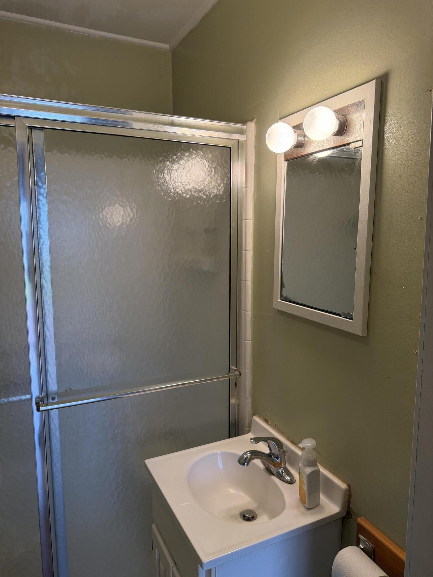 2945 Monnier Street Portage, IN 46368 - Photo 22 of 32 a bathroom with a sink and mirror