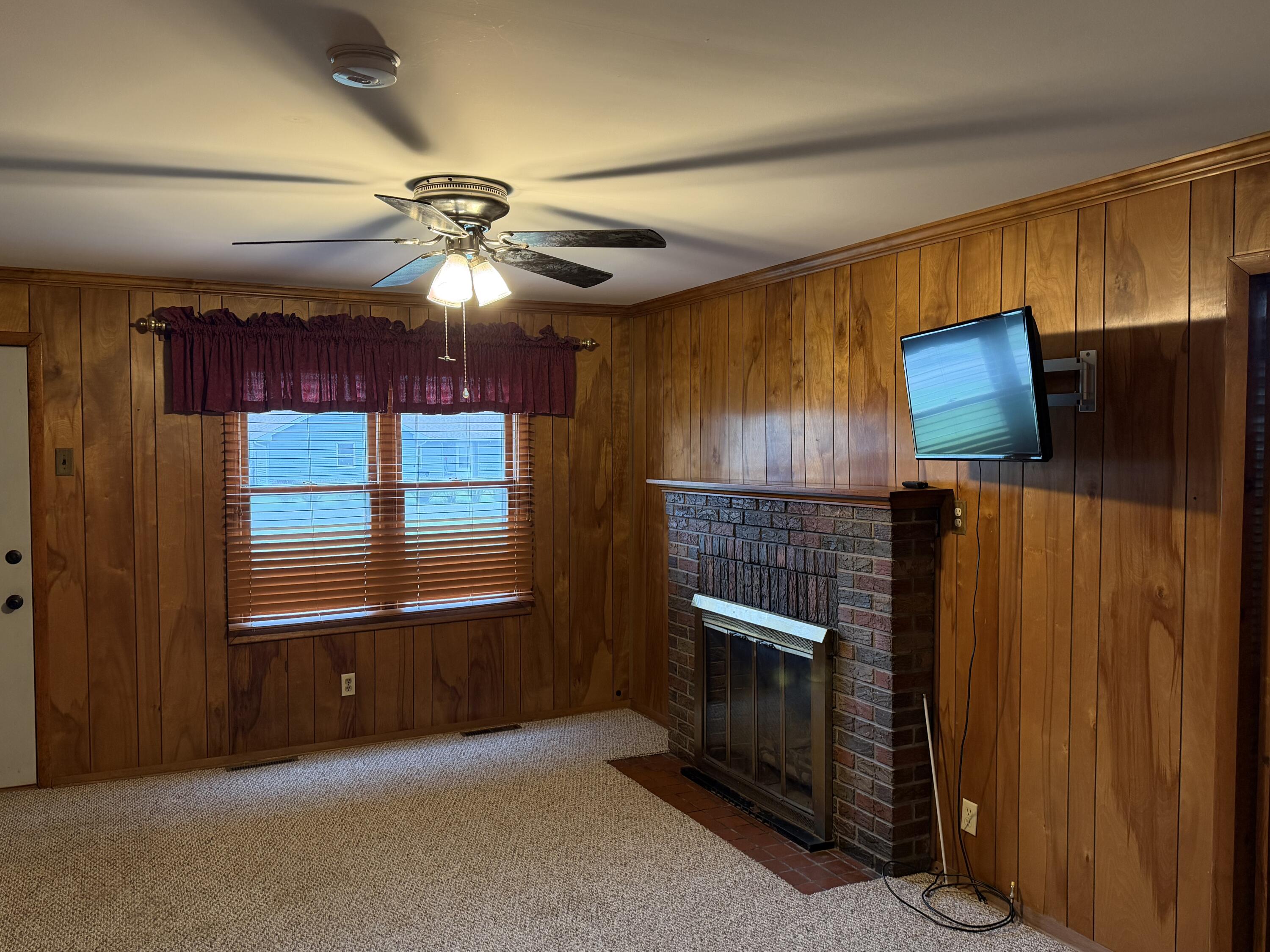 2945 Monnier Street Portage, IN 46368 - Photo 9 of 32 a living room with furniture and a fireplace